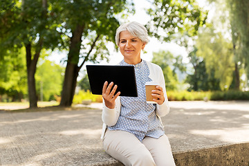 Image showing old woman with tablet pc and coffee at summer park