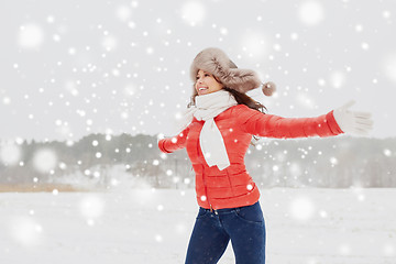 Image showing happy woman in winter fur hat having fun outdoors