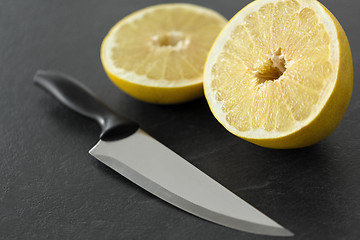 Image showing close up of chopped lemon and knife on table