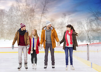 Image showing happy friends on outdoor skating rink