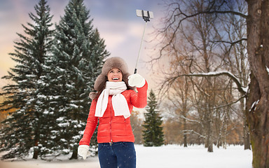 Image showing happy woman taking selfie over winter forest