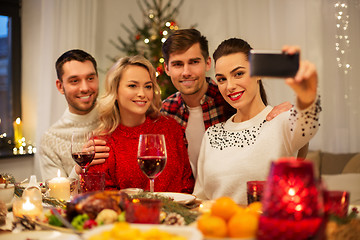 Image showing friends taking selfie at christmas dinner