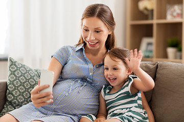 Image showing pregnant mother and daughter having video chat