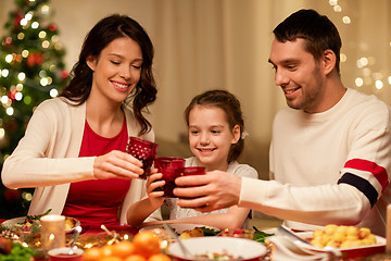 Image showing happy family having christmas dinner at home