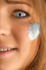 Image showing Portrait of a woman with the flag of the Argentina painted on her face.