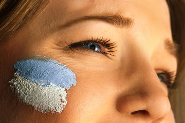 Image showing Portrait of a woman with the flag of the Argentina painted on her face.