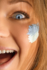 Image showing Portrait of a woman with the flag of the Argentina painted on her face.