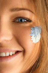 Image showing Portrait of a woman with the flag of the Argentina painted on her face.