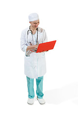 Image showing Beautiful young woman in white coat posing at studio. Full length studio shot isolated on white.