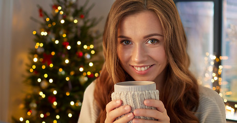 Image showing happy woman with cup of tea or coffee on christmas