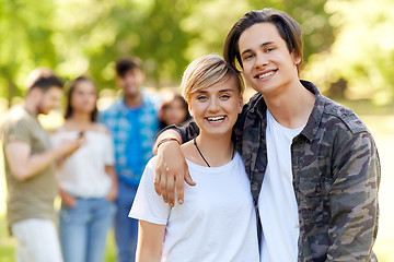 Image showing happy teenage couple hugging at summer park