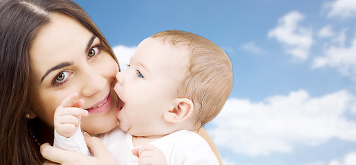 Image showing mother with baby over sky background