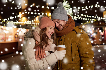 Image showing happy young couple with coffee at christmas market