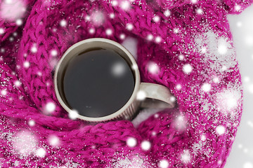 Image showing close up of tea or coffee and winter scarf in snow