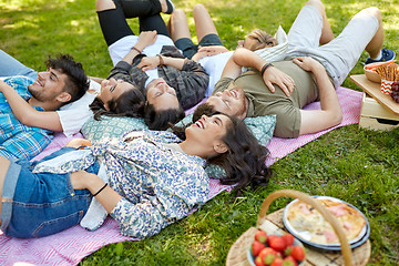 Image showing happy friends chilling on picnic blanket at summer