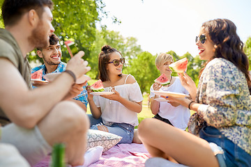 Image showing happy friends eating watermelon at summer picnic