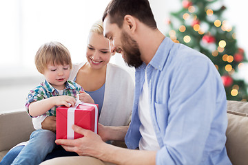 Image showing happy family with christmas gift at home