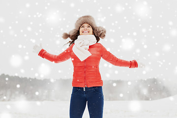 Image showing happy woman in winter fur hat having fun outdoors