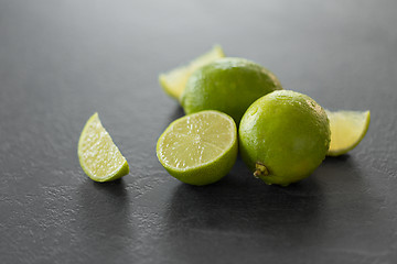 Image showing close up of limes on slate table top