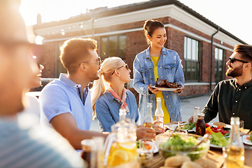 Image showing friends at barbecue party on rooftop in summer