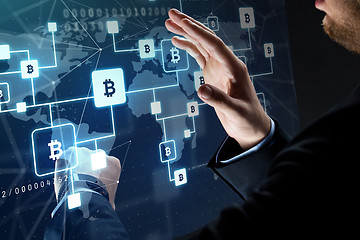 Image showing close up of businessman with bitcoin block chain