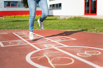 Image showing Legs of kids jumps hopscotch