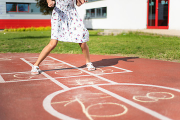 Image showing Legs of kids jumps hopscotch