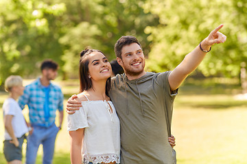 Image showing happy couple looking at something in summer park