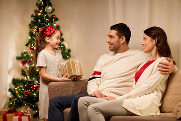 Image showing happy family with christmas present at home