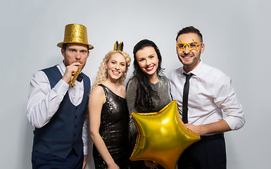 Image showing happy friends with golden party props posing