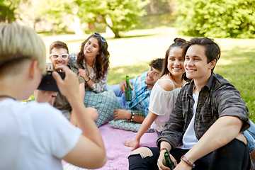 Image showing friends with drinks photographing at summer picnic