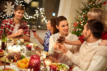 Image showing friends celebrating christmas and drinking wine