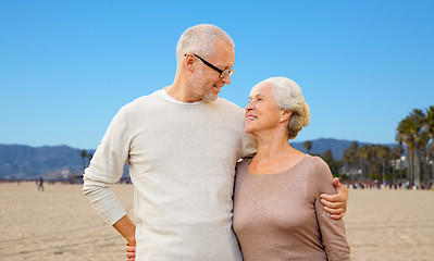 Image showing happy senior couple hugging over venice beach