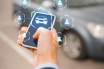 Image showing businessman hand with smartphone car sharing app