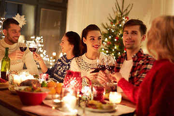 Image showing happy friends celebrating christmas at home feast