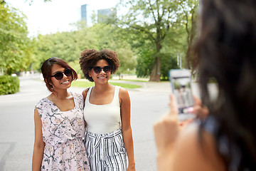 Image showing woman photographing her friends in summer park