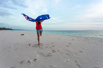 Image showing Woman leaping into the air with Australian Flag