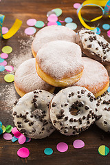 Image showing Krapfen, Berliner or  donuts with streamers and confetti