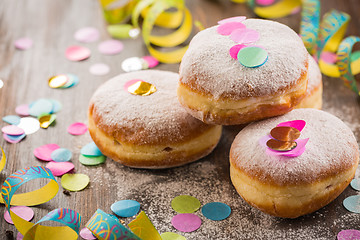 Image showing Krapfen, Berliner or  donuts with streamers and confetti