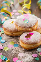 Image showing Krapfen, Berliner or  donuts with streamers and confetti