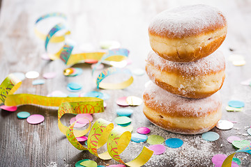 Image showing Krapfen, Berliner or  donuts with streamers and confetti