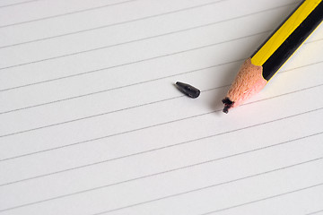 Image showing Broken pencil on writing pad

