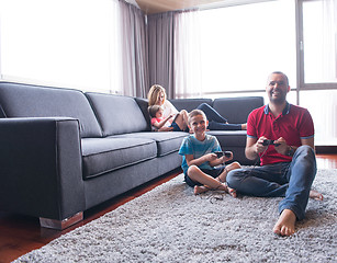 Image showing Happy family playing a video game