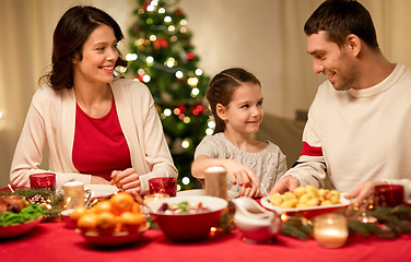 Image showing happy family having christmas dinner at home