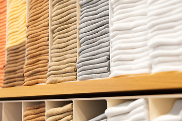 Image showing close up of shelves with clothes at clothing store