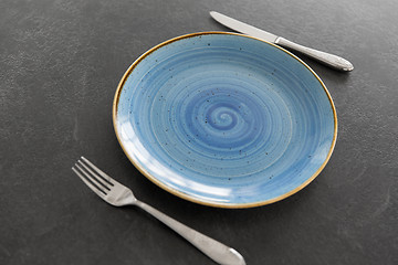 Image showing close up of plate, fork and knife on table