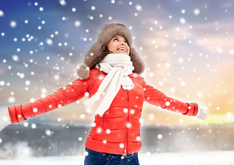 Image showing happy woman in winter fur hat outdoors