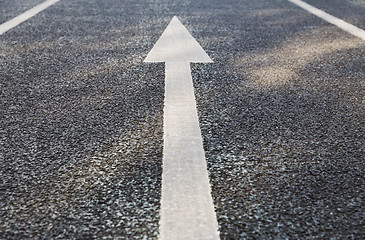 Image showing close up of arrow road surface marking on asphalt