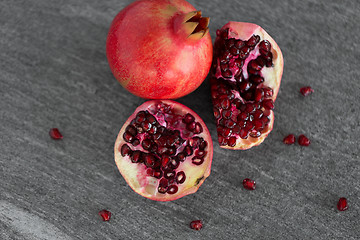 Image showing close up of pomegranate on stone table