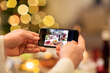 Image showing hands photographing food at christmas dinner